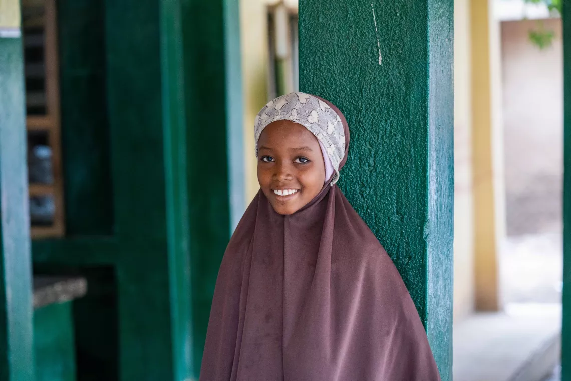 Safiyya, 10, smiles as she waits to receive a human papillomavirus (HPV) vaccination in Katsina, Nigeria.