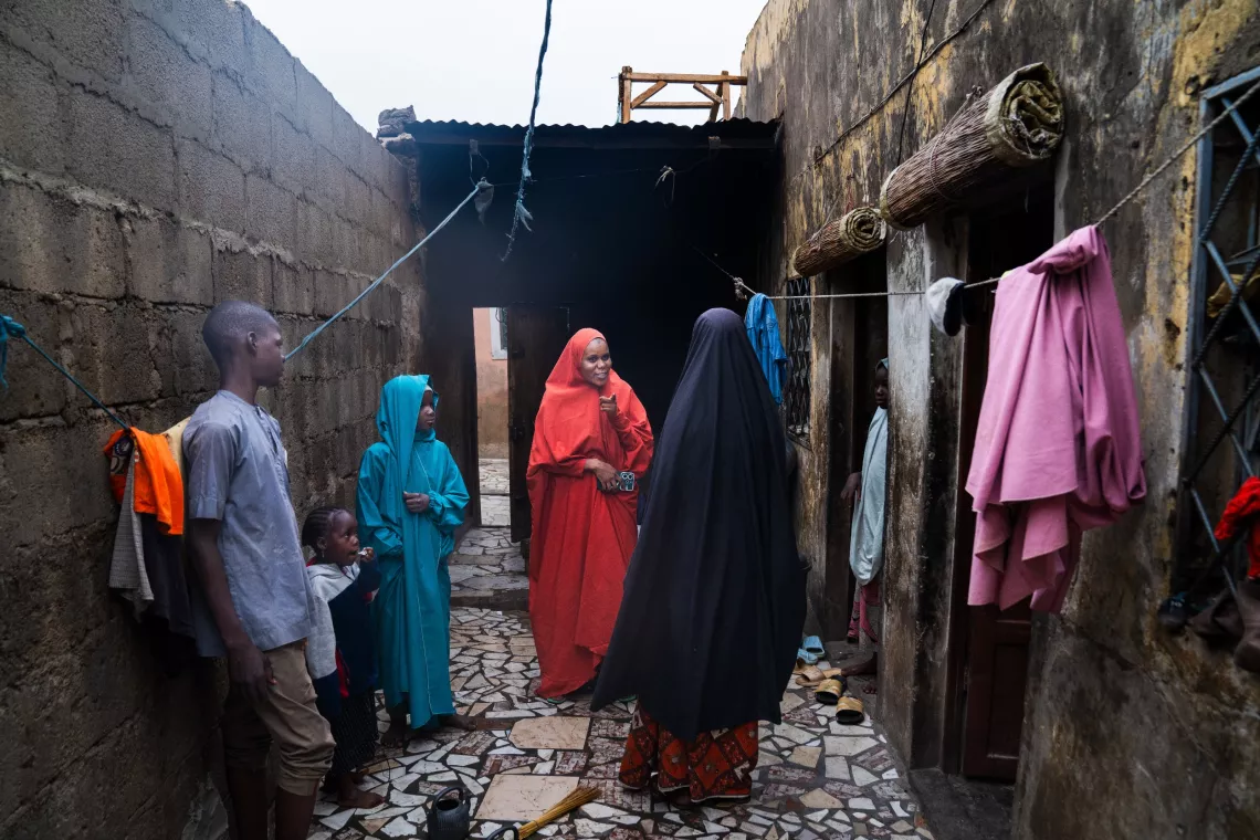 Volunteer Community Mobilizer (VCM), Shamsiyya Abdullah Jariri, 30, middle, visits the home of her brother&rsquo;s family to encourage them to allow their daughter to receive the human papillomavirus (HPV) vaccination in Katsina, Nigeria, on 30 May 2024.