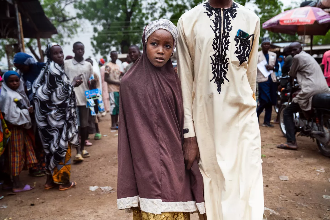 Safiyya, 10, walks with her brother, Abdulrahman, on route to receive a human papillomavirus (HPV) vaccination in Katsina, Nigeria, on 30 May 2024.