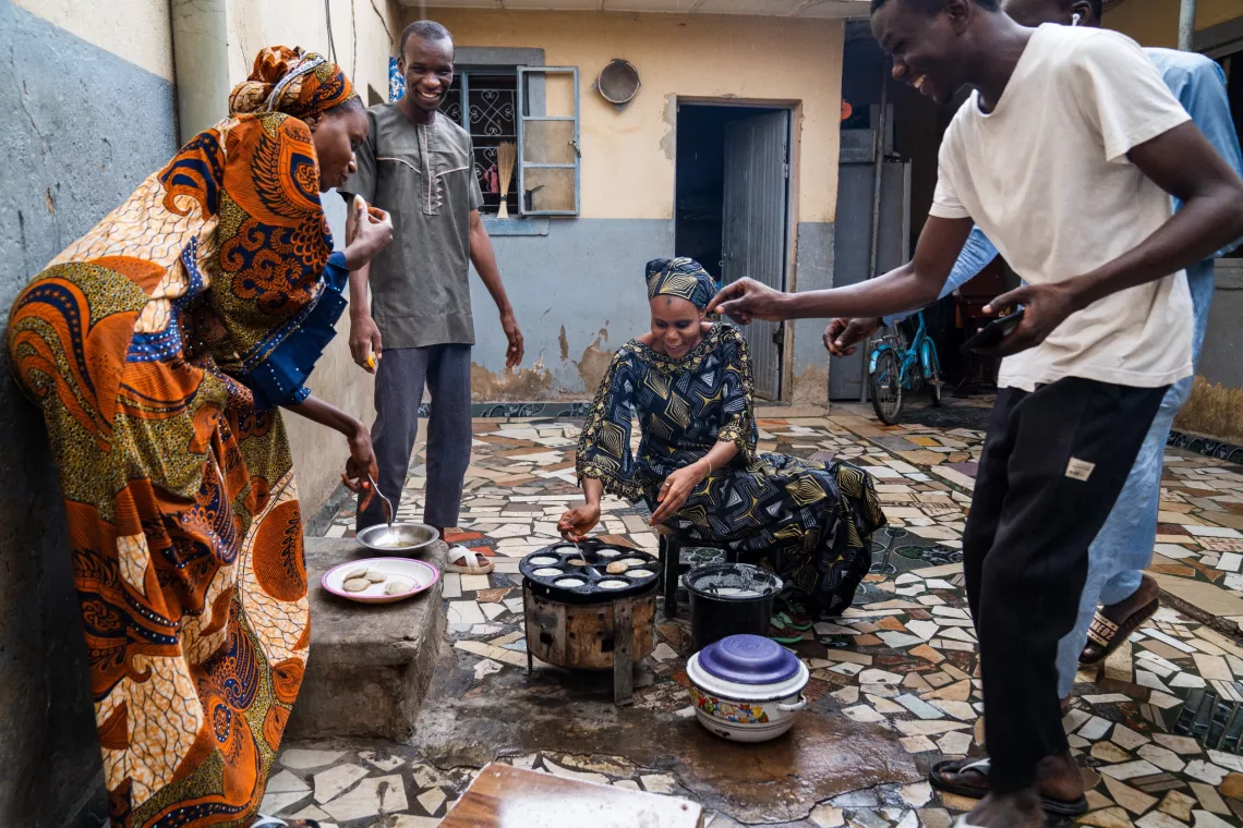 Volunteer Community Mobilizer (VCM), Shamsiyya Abdullahi Jariri, 30, prepares food for her family at her home in Katsina, Nigeria on 30 May 2024.