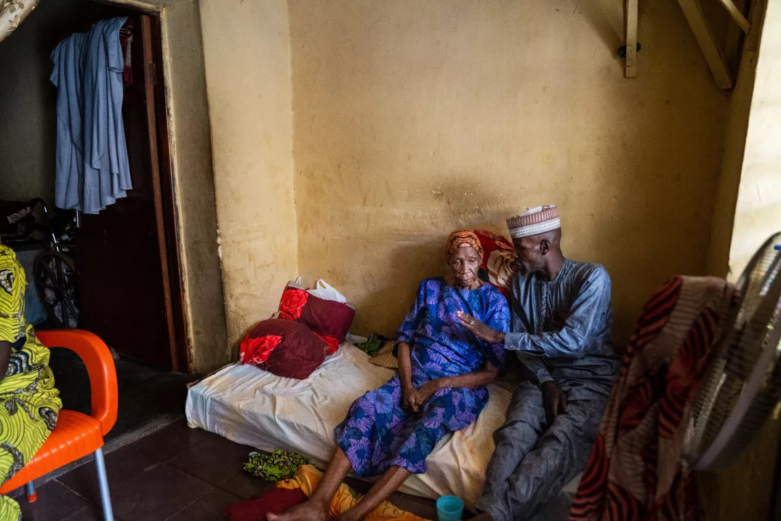 Hassan Habibu speaks with his mother, Fatima, about the benefits of the human papillomavirus (HPV) vaccine at her home in Katsina, Nigeria.