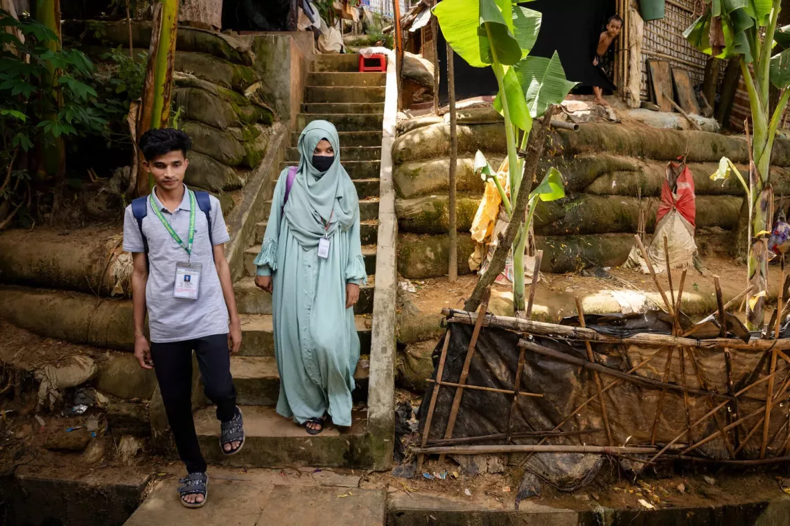Bangladesh. Two nutrition volunteers walk through a Rohingya refugee camp in Cox's Bazar.