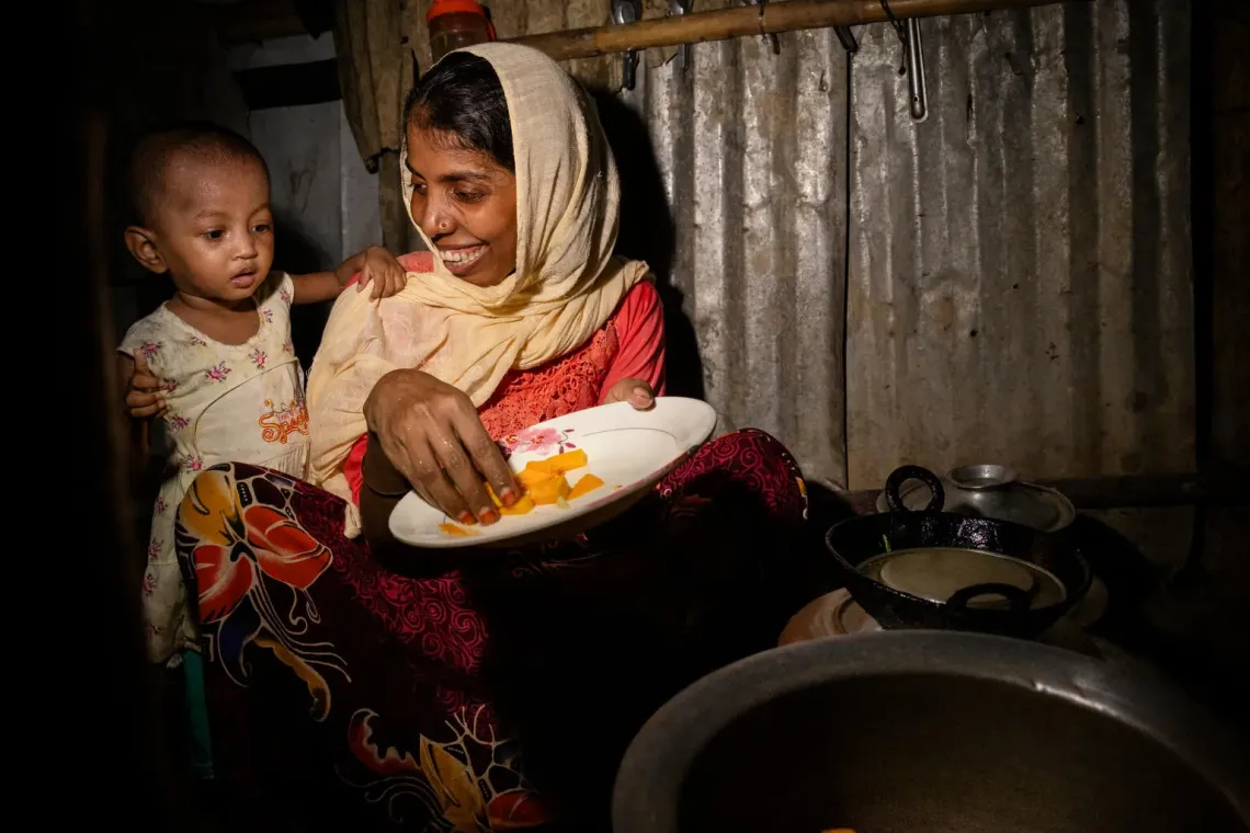 Bangladesh. A mother prepares a meal for her daughter at their shelter in the Rohingya refugee camps in Cox&rsquo;s Bazar.