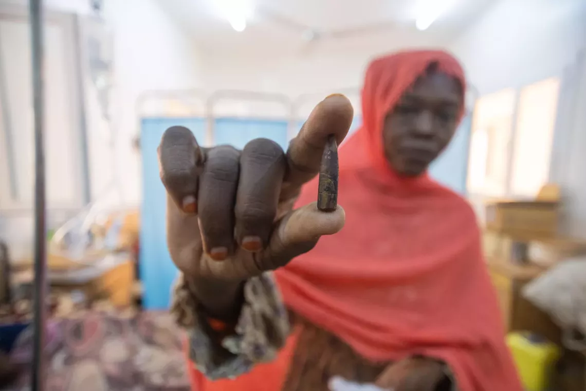 Sudan. A woman holds the bullet that was removed from the back of her daughter&rsquo;s head at Aljekaika hospital, about 90 kilometres from Khartoum.
