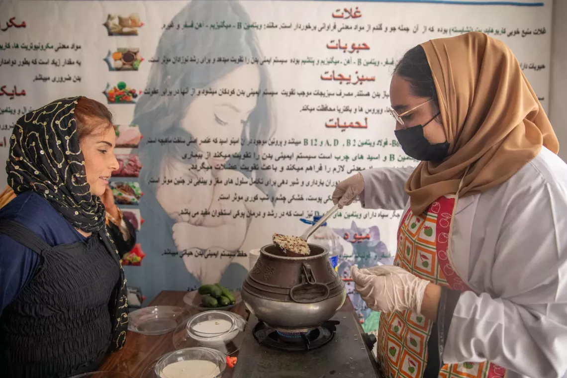 Afghanistan. A nutrition counsellor leads a cooking demonstration for mothers at a daycare centre in Kabul.