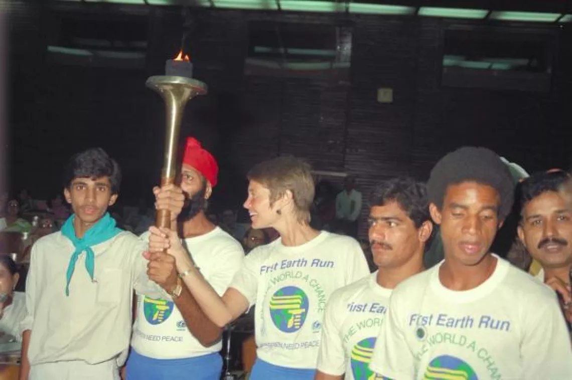 Runners hold a torch. India, 1986.