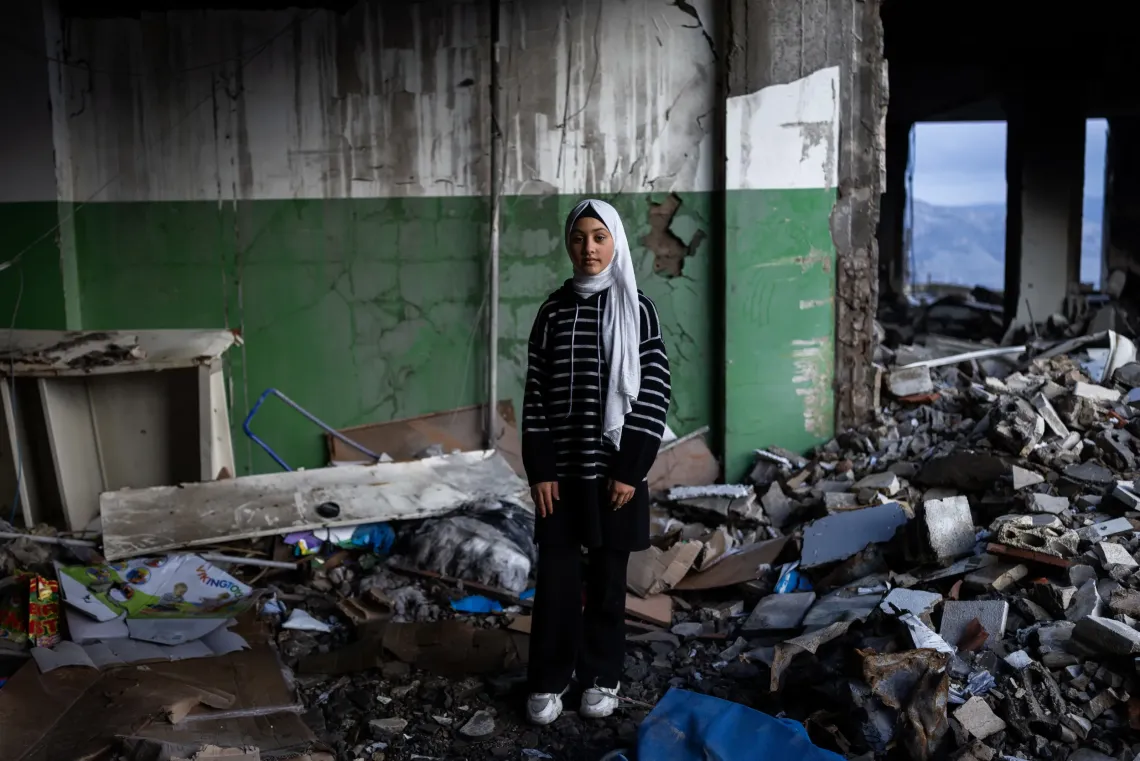 Khiam, Lebanon: Khouloud, 10, a girl, poses for a portrait inside her destroyed school. 