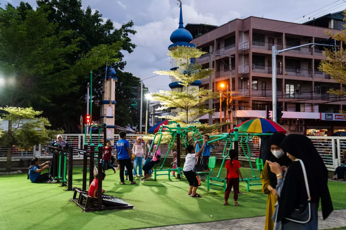 Children playing on the rides in a public park