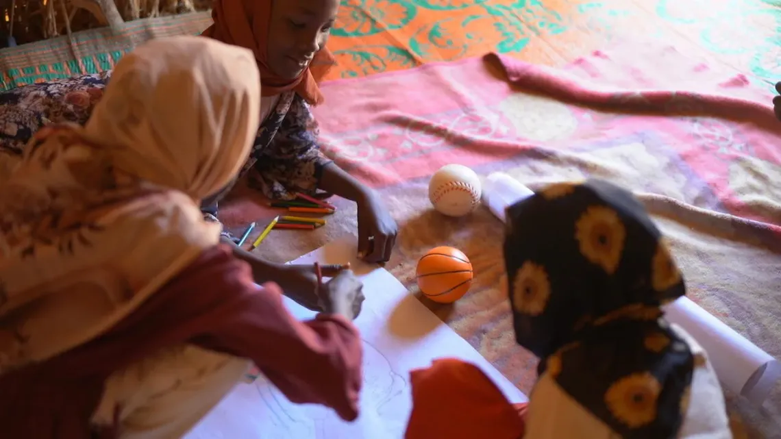 Sudan. Children draw at a UNICEF-supported child-friendly space in Tawila.