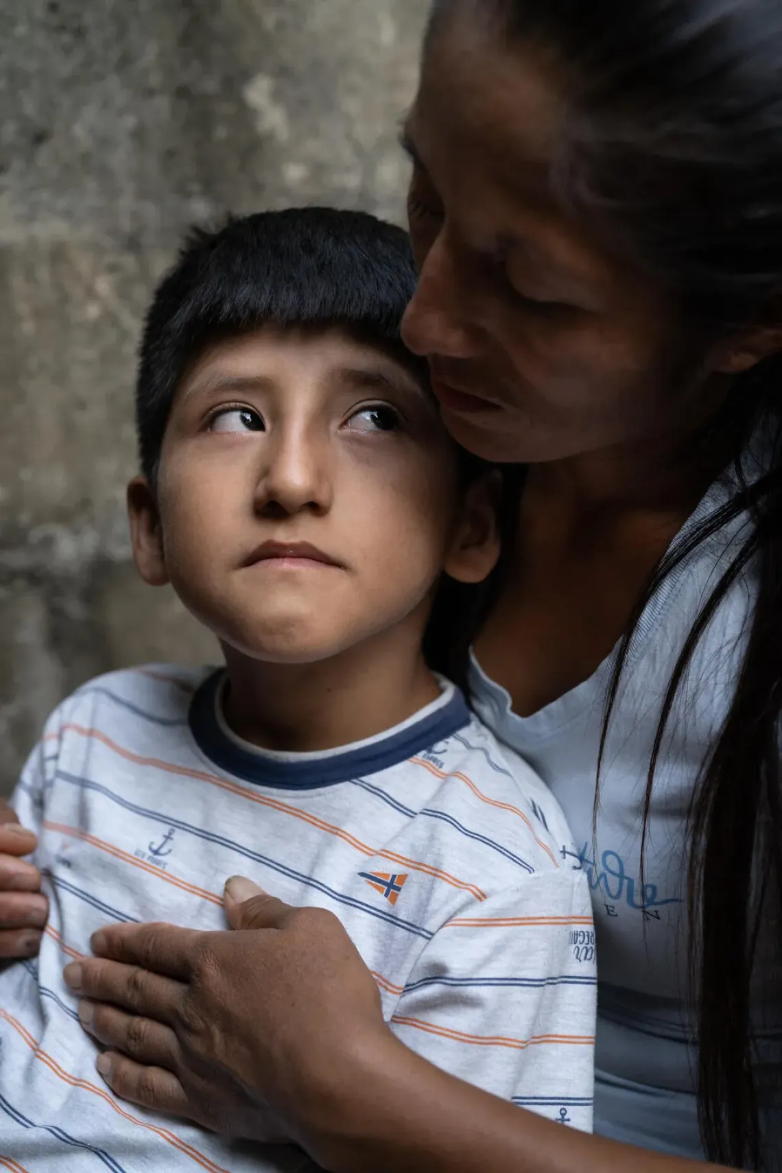 Peru. Hansel is hugged by his mother, Nayci, at their home in Ayacucho.
