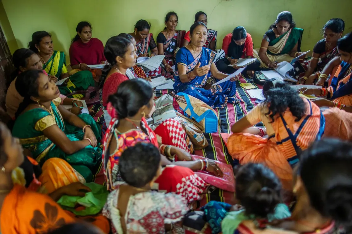 Women sitting on floor in a meeting.