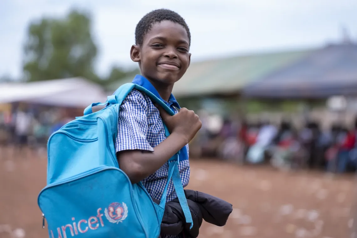 A boy stands with his UNICEF bag in Mondossou school in Dedougou, Burkina Faso