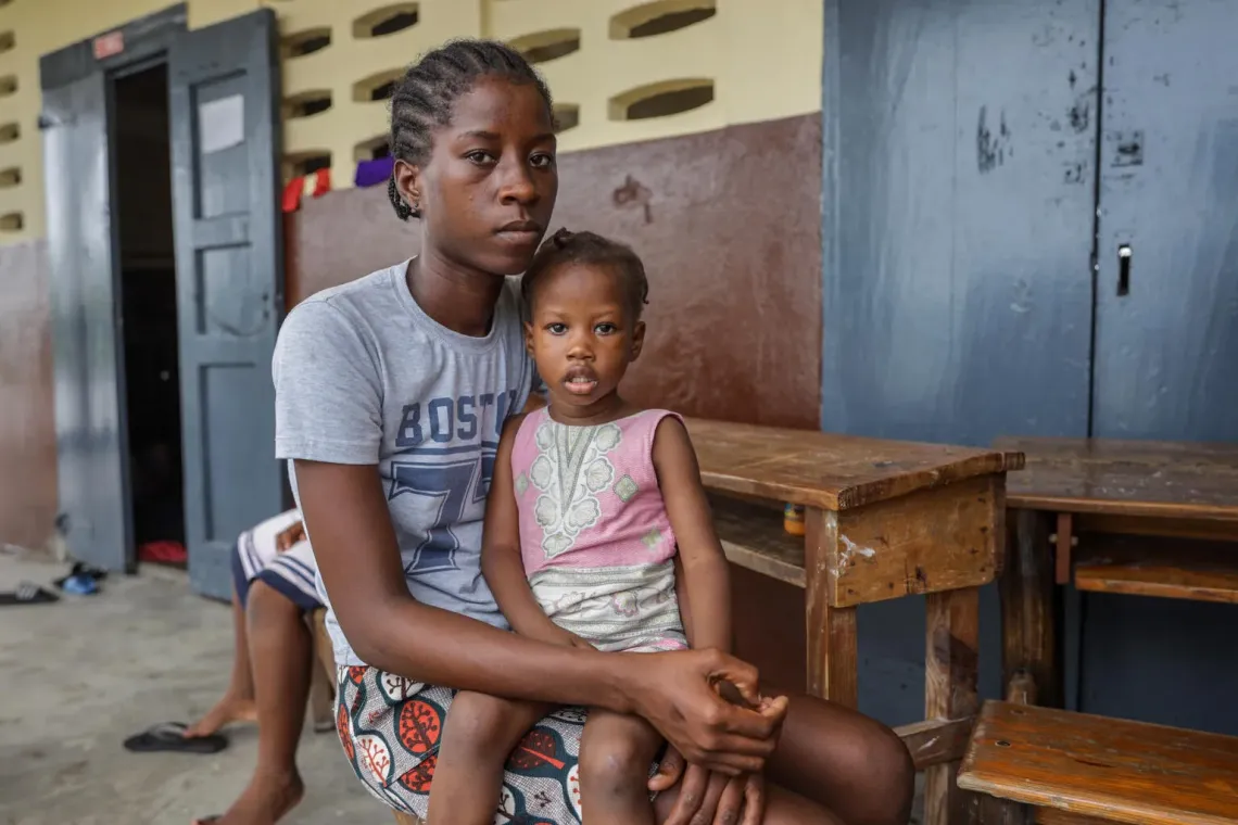 Haiti. A woman sits with her daughter at a school converted into a shelter. 