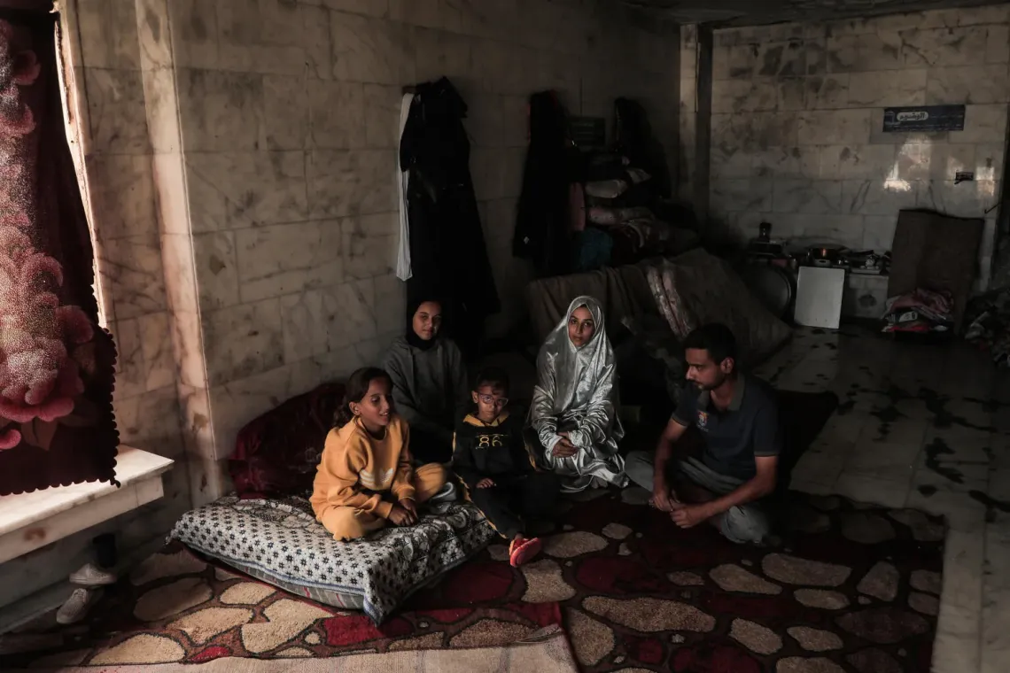 Gaza. Una familia sentada en el piso de una mezquita en la que se refugian.