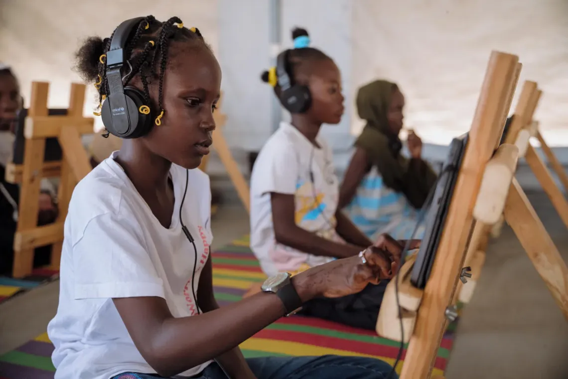 Sudan. A girl uses a tablet during a structured e-learning session at a UNICEF-supported child friendly space in Port Sudan.