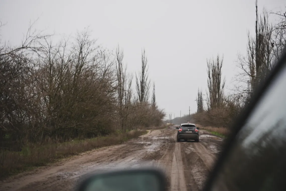 Ukraine. Cars are pictured driving along a muddy rural road stretching between Bashtanka and Novoivanivka in Mykolaiv region.