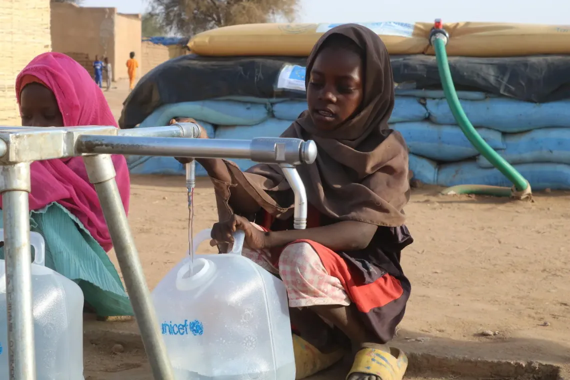 Sudan. A girl collects water from a water point installed by UNICEF in a camp for displaced people in Tawila.