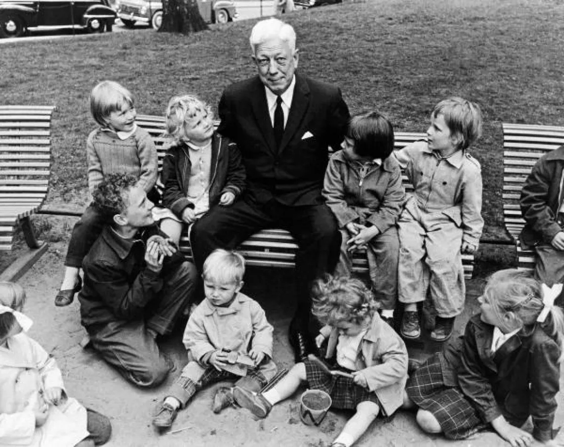UNICEF Executive director Maurice Pate sits with children.