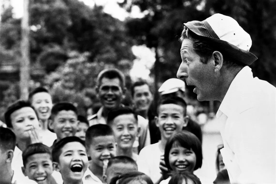 UNICEF Goodwill Ambassador Danny Kaye entertains a group of children in Thailand.