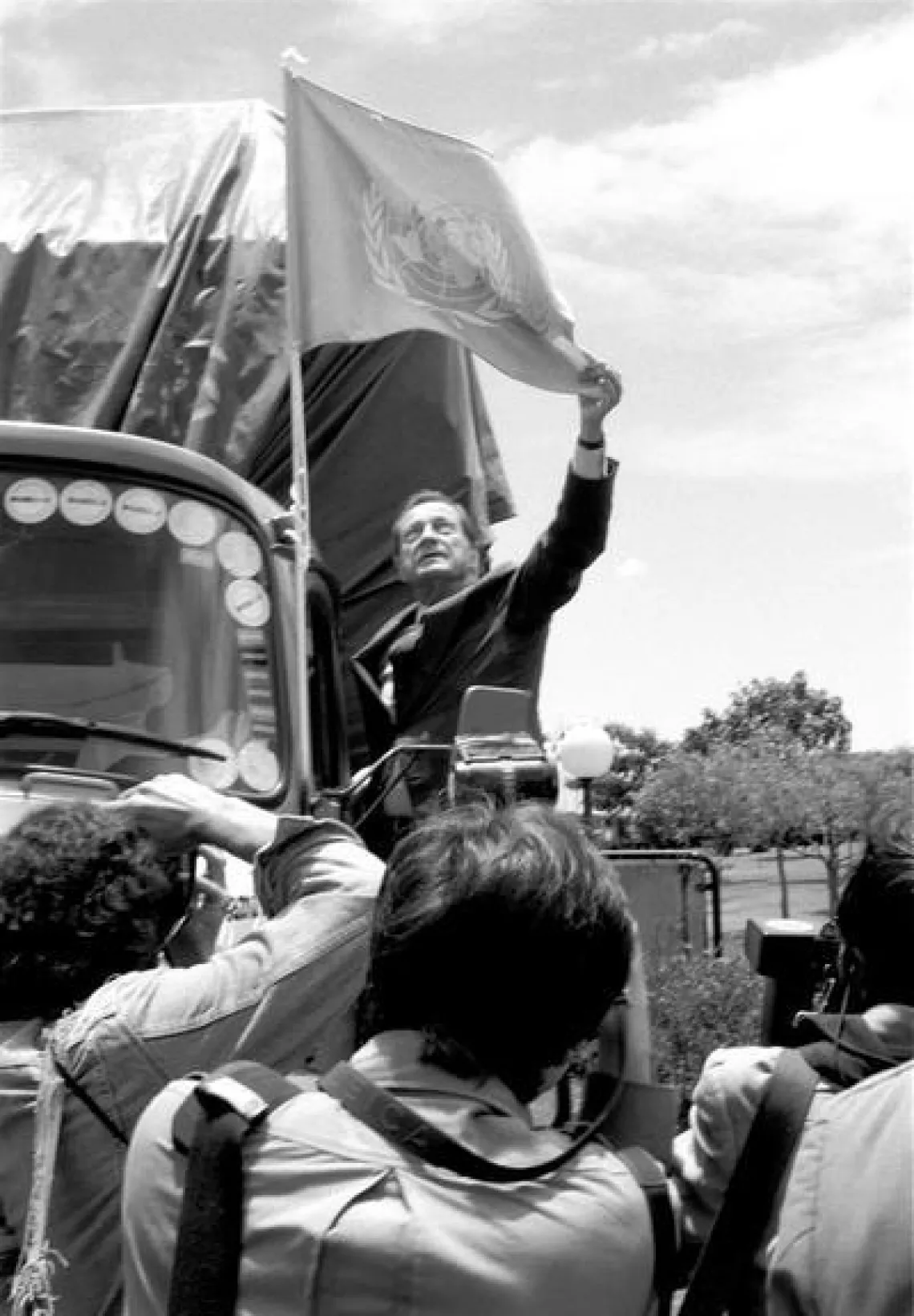 James Grant raises the United Nations flag on a relief truck leaving Nairobi.