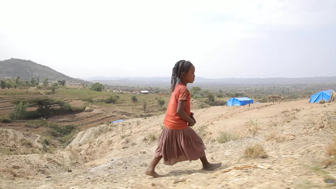 Ethiopia. A girl walks near a site for internally displaced persons.