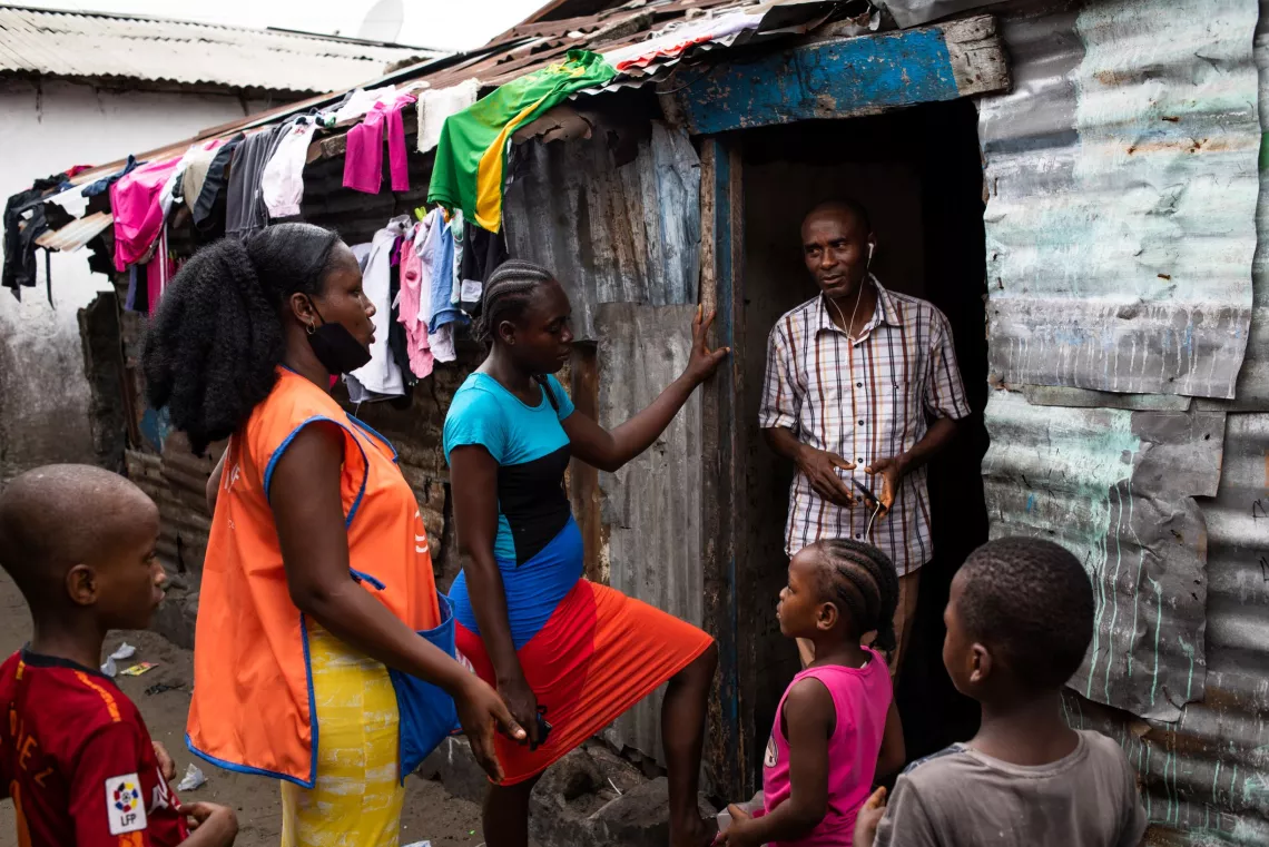 Liberia. Volunteers for a polio vaccination campaign talk to parents in Monrovia.