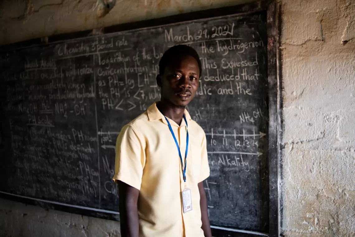 Liberia. A teacher stands in a classroom.