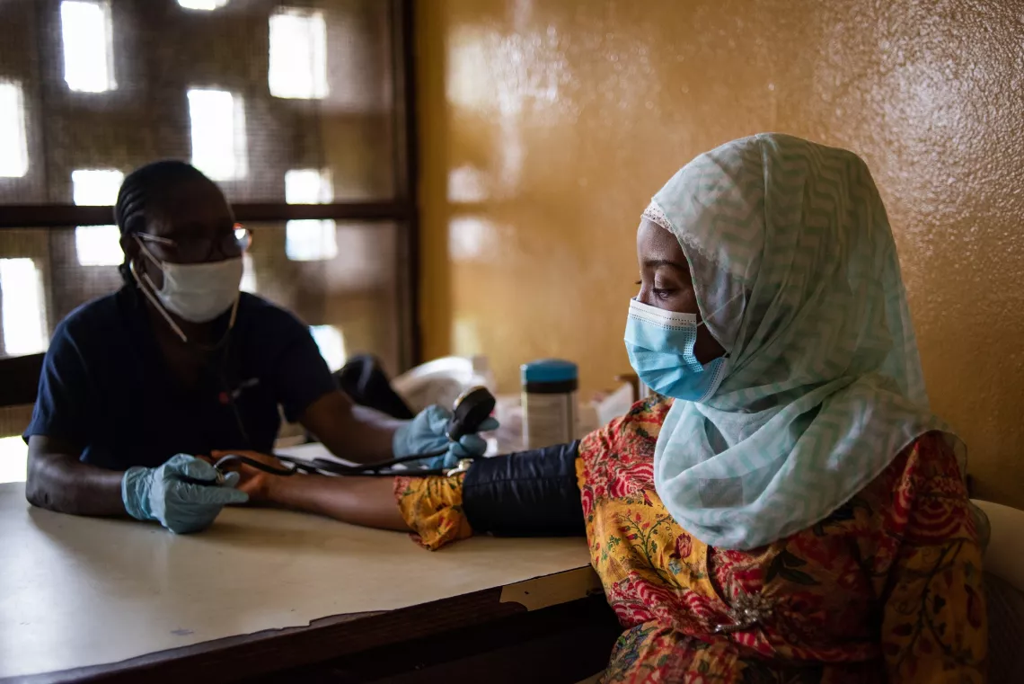 Liberia. A midwife takes the blood pressure of a pregnant woman.