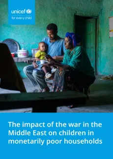 A couple feeding their infant child inside their clay-walled house