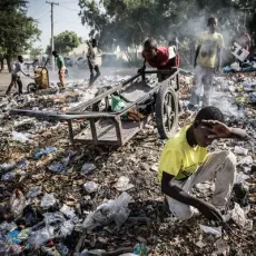 A boy digs through a rubbish dump 