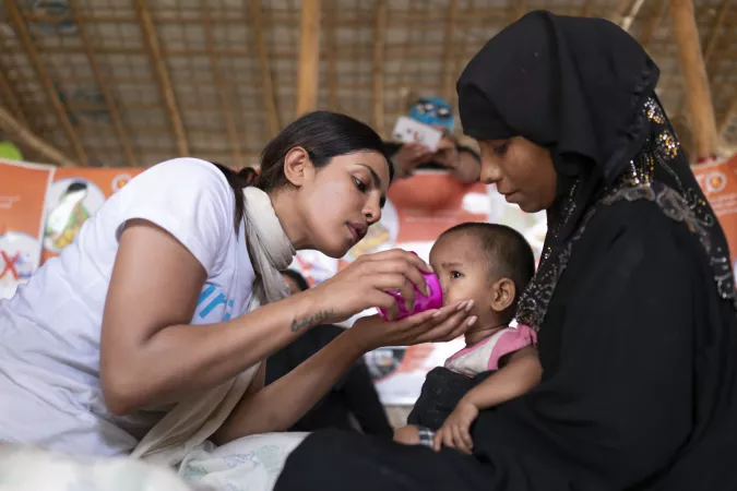 UNICEF Goodwill Ambassador Priyanka Chopra helps feed a Rohingya refugee baby at a UNICEF-supported therapeutic feeding center for malnourished children.in Jamtoli camp, Cox's Bazar district, Bangladesh on 23 May 2018.