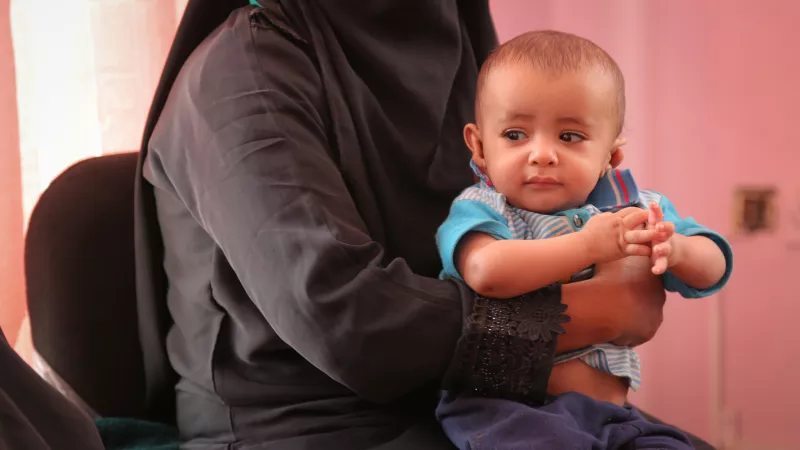 A child being treated for malnutrition waits to receive Ready To Use Therapeautic Food at the UNICEF-supported Alsabeen Hospital in Sana'a, Yemen. 27 June 2018