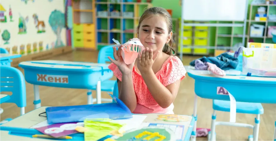 A child in a classroom working on a project
