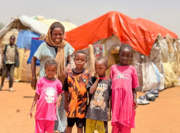 On 24 June, in Sudan, women and children displaced by the fighting in Al Obeid seek refuge in Tagat gathering...