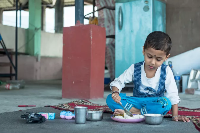 Three-year-old Aarav Adhikari eats lunch at his grandparents&rsquo; home in Nawalpur District in southern Nepal.