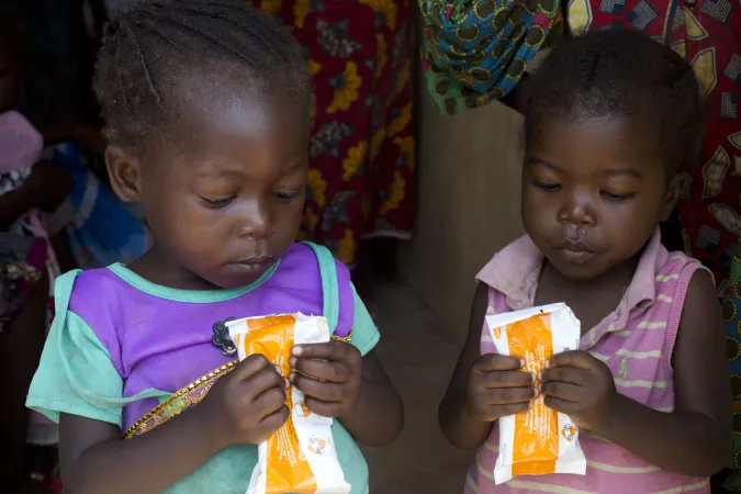 Democratic Republic of the Congo. Two children drink a nutrition drink.