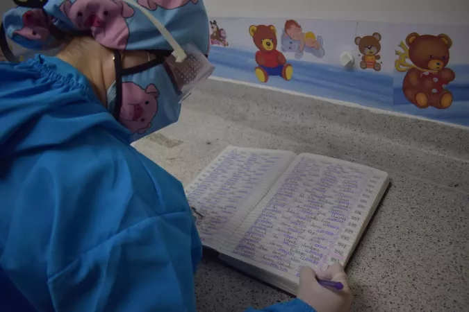 A healthcare provider fills in a form.