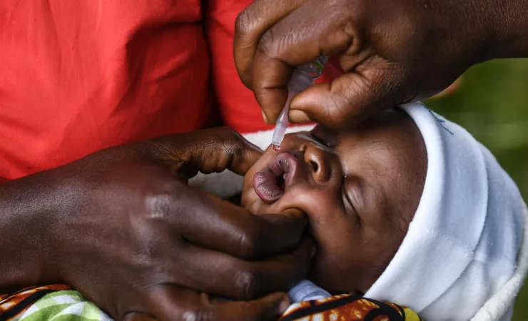 Baby is immunized using a dropper