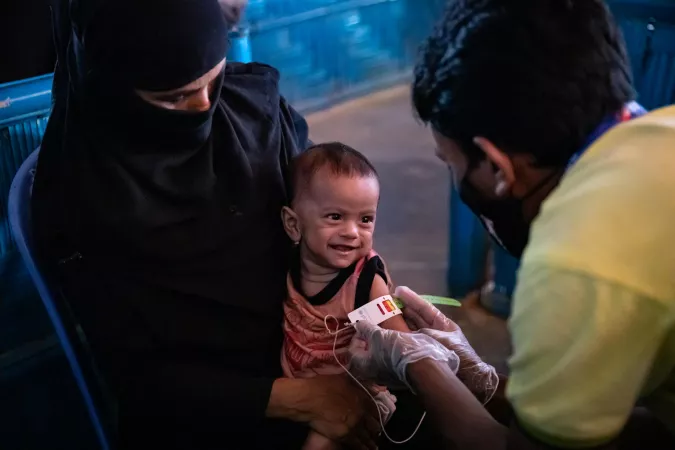 Bangladesh. A health worker measures MUAC of a Rohingya refugee baby at a UNICEF Integrated Nutrition Facility.