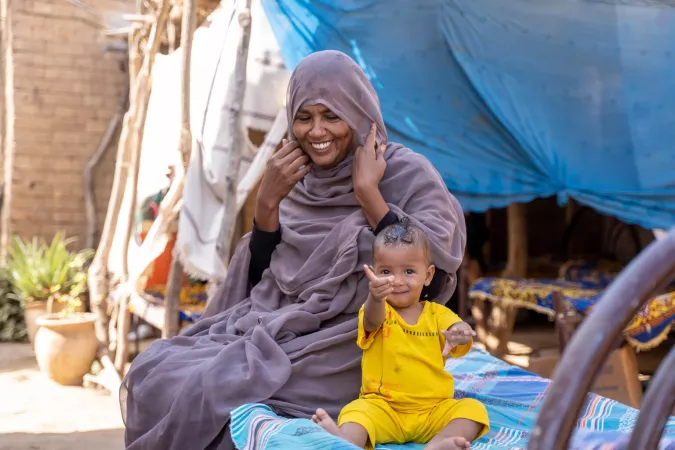 Sabna Mohamed sentada con su hija de nueve meses, Fatuma, en su casa en la aldea de Wager, localidad del norte del Delta, estado de Kassala, Sud&aacute;n.