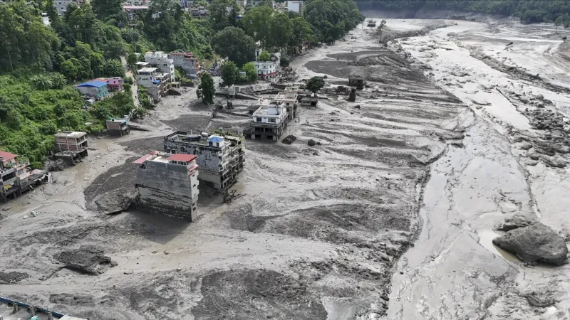 An aerial view of a settlement swept away in mud.