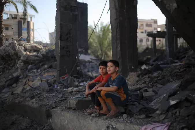 Two Palestinian children sitting in the rubble of what is left of their house in Rafah city, southern the Gaza Strip.