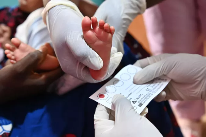 A blood sample is collected from a baby's foot.