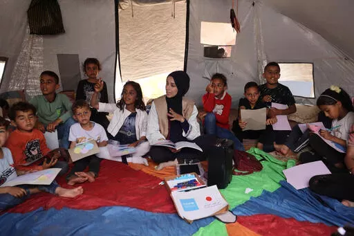 A group of children participates in a session on how to remember their names and their parents' names in southern Gaza Strip.