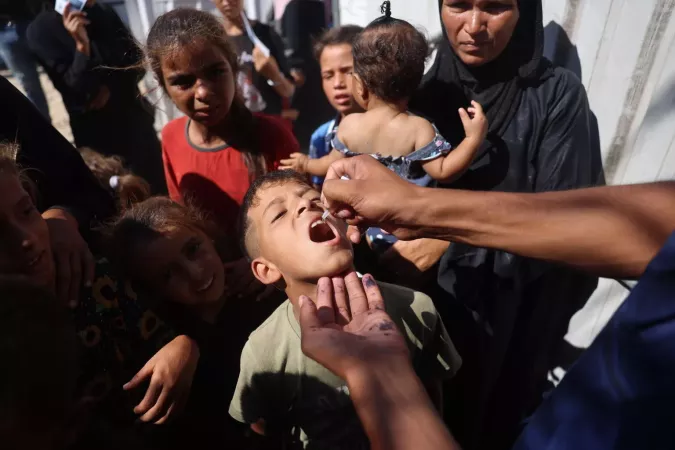 A child receives a polio vaccine at a health clinic in Khan Younis, southern Gaz Strip.