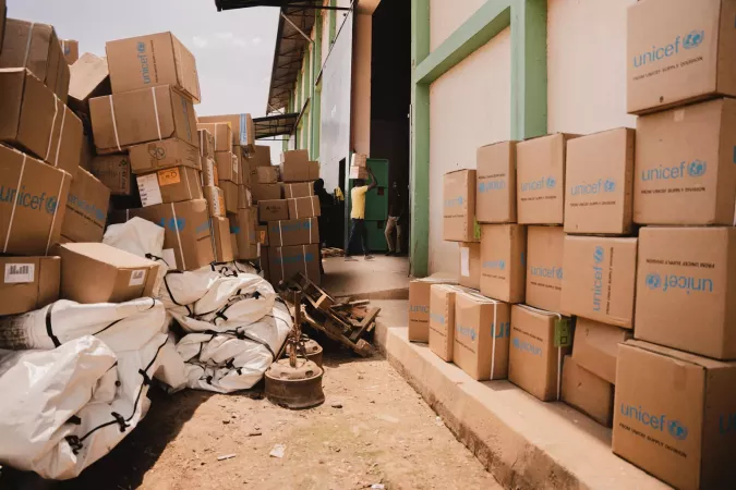 UNICEF boxes stacked outside.