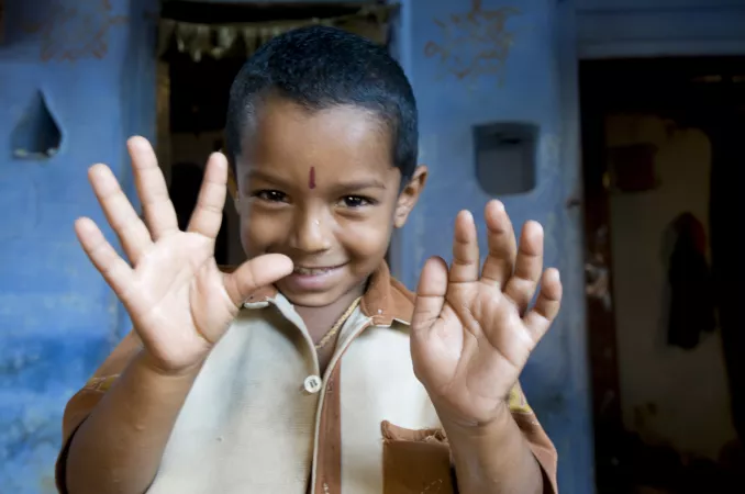 A boy shows his hands, India