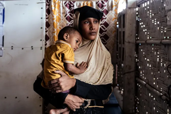 Woman holding child looking outside
