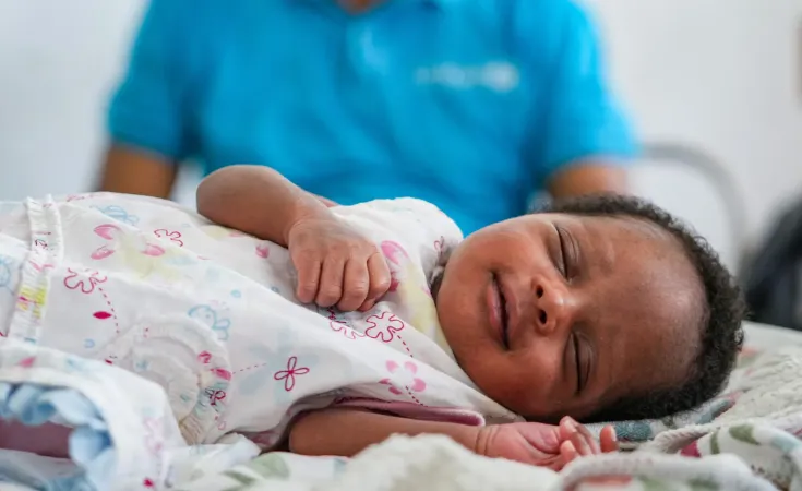 A baby sleeps after receiving their first ever vaccine, DTP1.