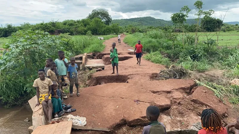 Children standing on flooded road